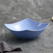 Blue ceramic bowl with dimensions on a gray surface