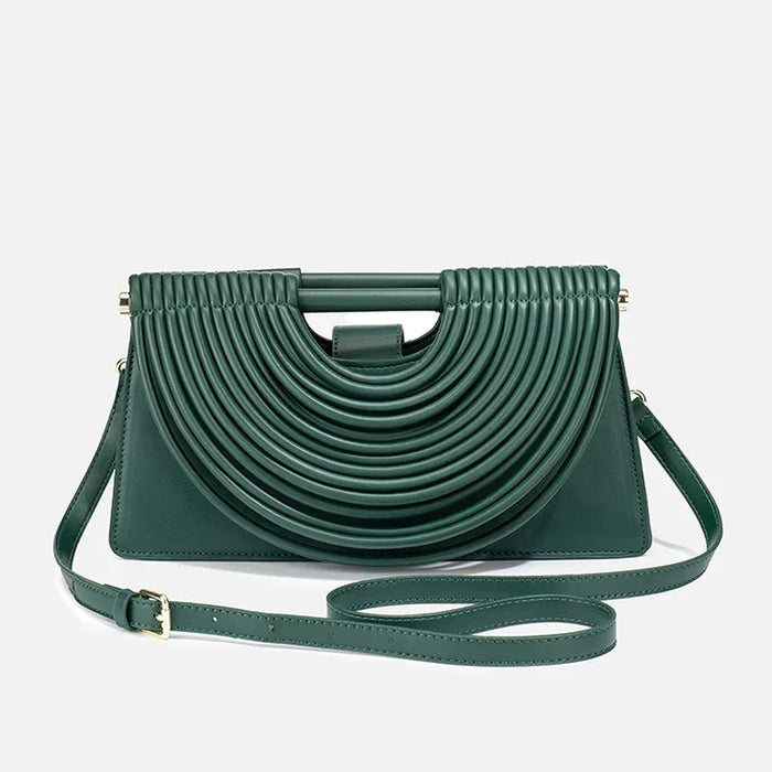 Green handbag with a unique design on a light gray background