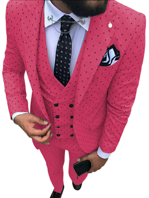 Pink suit with black polka dots worn by a person on a white background