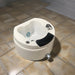 White sink with black basin on a tiled floor