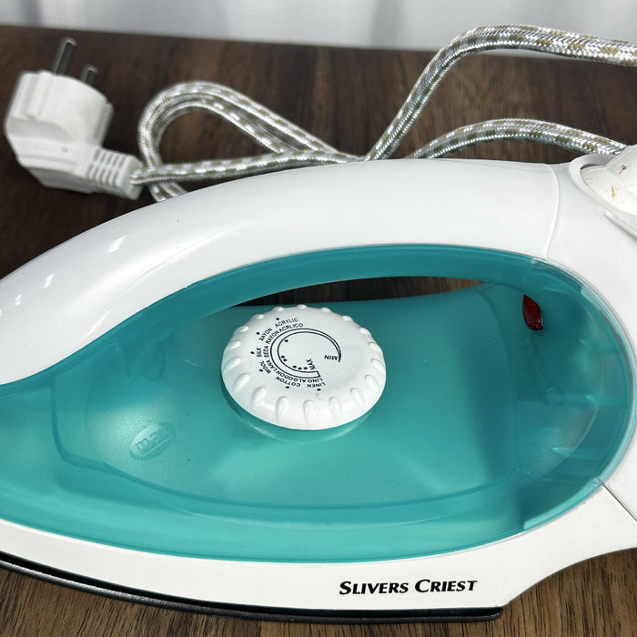 White and turquoise iron with 'Slivers Priest' branding on a wooden surface.