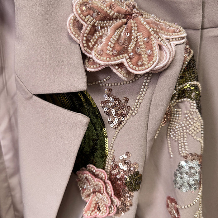 Close-up of a beige coat with floral embellishments and sequins.