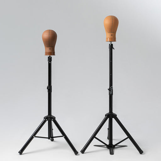 Two wooden dummies on black stands against a gray background