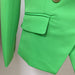 Close-up of a green jacket with a pocket and button on a neutral background
