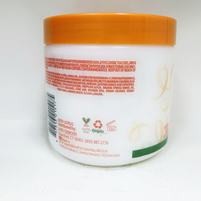Back of a white jar with an orange lid on a white background