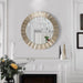 Round decorative mirror with a gold frame on a white wall above a fireplace.