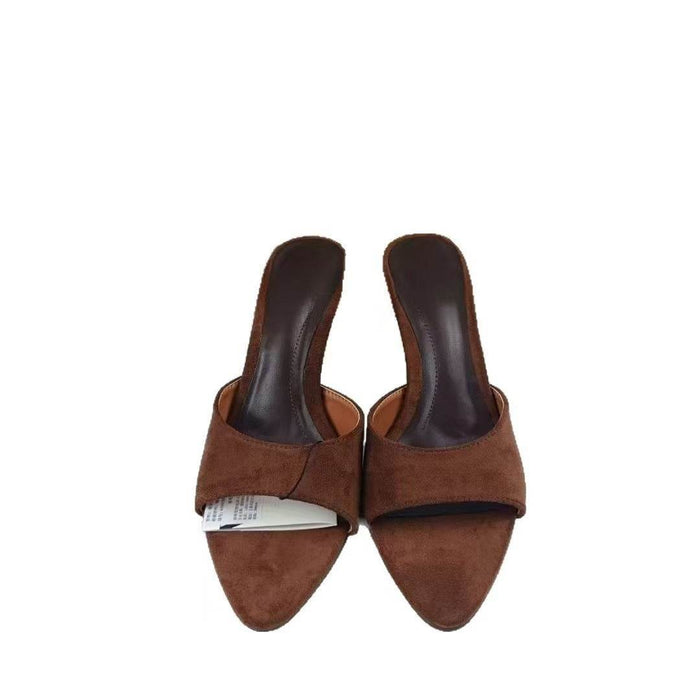 Pair of brown suede high-heeled shoes on a white background