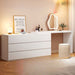 White dresser with mirror and decorative items in a room setting