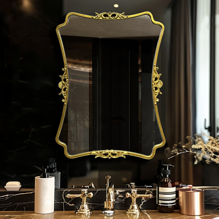 Decorative gold-framed mirror above a bathroom vanity with various items.