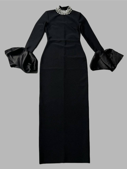 A woman wearing a black long-sleeve dress with a round neckline and a high waist, featuring a solid color with a zipper at the placket.