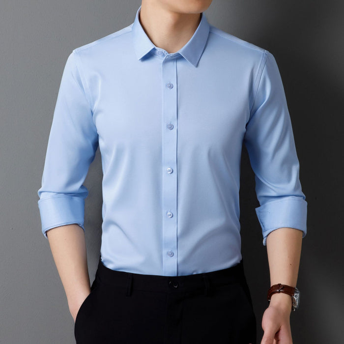 Light blue dress shirt with rolled-up sleeves worn by a person on a gray background