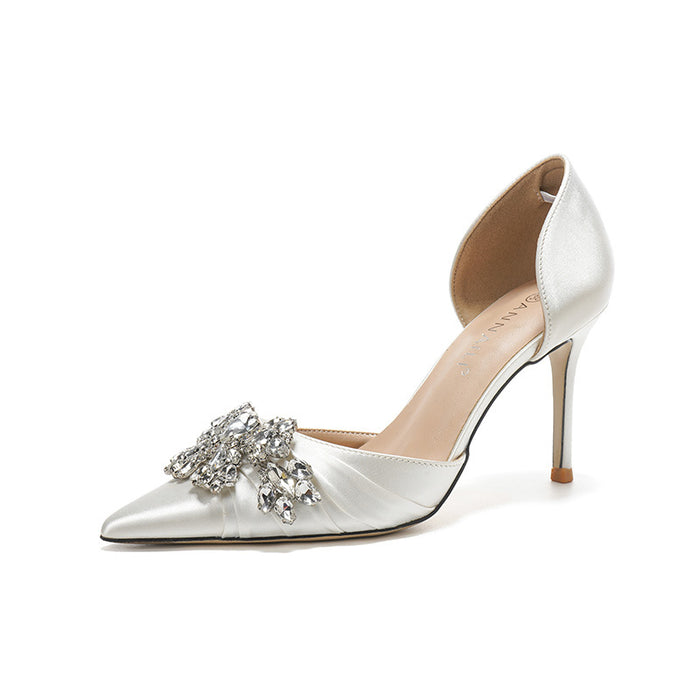 Silver high-heeled shoe with embellishments on a white background