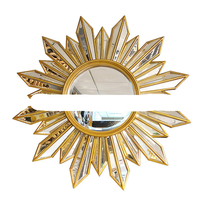 Decorative wall mirror with gold and crystal design on a white background