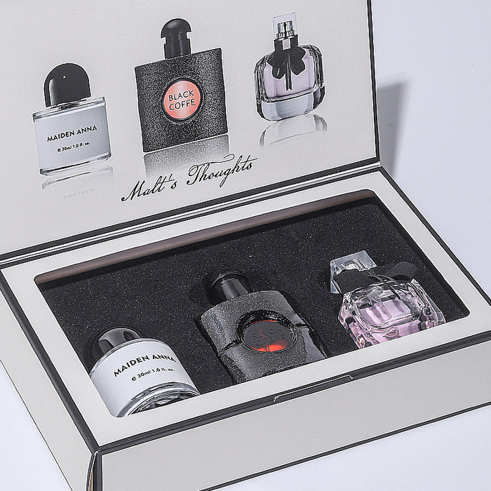 Set of miniature perfume bottles in a display case with 'Malt's Thoughts' branding.