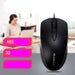 Black computer mouse with text highlighting features on a blurred office background