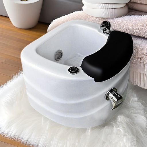 White sink with black faucet on a white rug