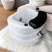 White sink with black faucet on a white rug
