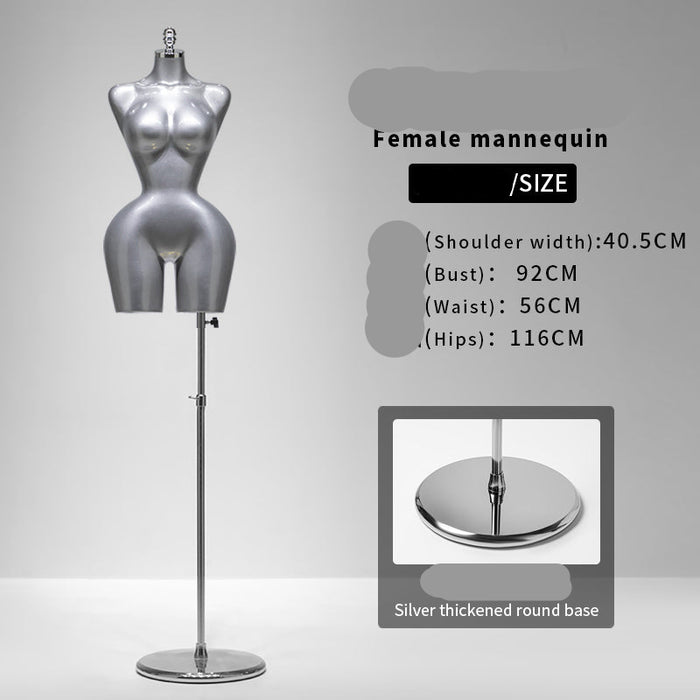 Silver female mannequin with stand on a gray background