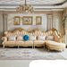 Luxurious living room with ornate sofa, chandelier, and decorative elements.