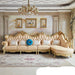 Luxurious living room with ornate sofa, chandelier, and decorative elements.