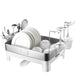 Dish drying rack with plates, glasses, and utensils on a white background