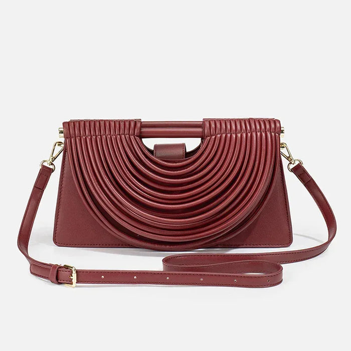 Maroon handbag with a unique design on a white background