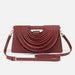 Maroon handbag with a unique design on a white background