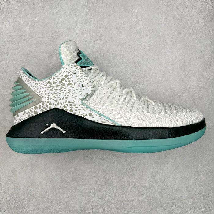 White and teal sneaker on a gray background