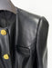 Black leather jacket with gold buttons on a white background