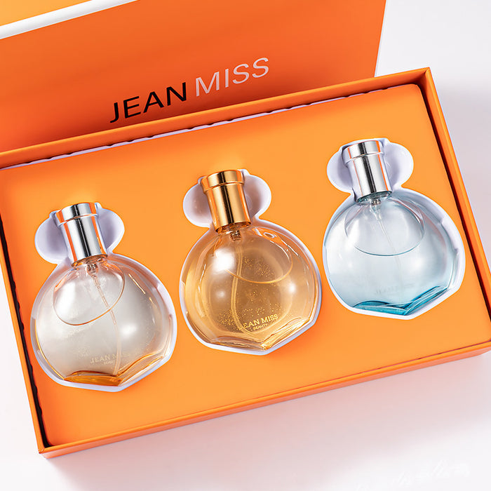Three perfume bottles in a 'Jean Miss' box on a light background