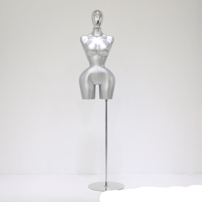 Silver mannequin on a stand against a white background