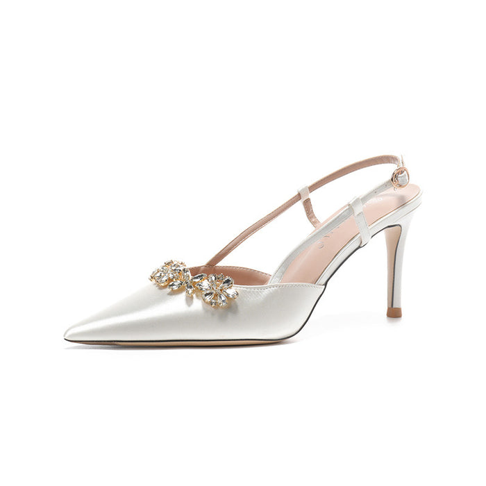White high-heeled shoe with a decorative bow on a white background