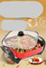 Electric pot with food inside on a beige background