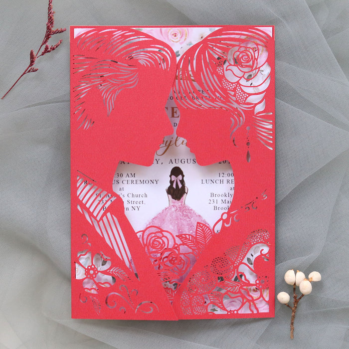 Red and white laser-cut wedding invitation with floral and butterfly design on a gray background.