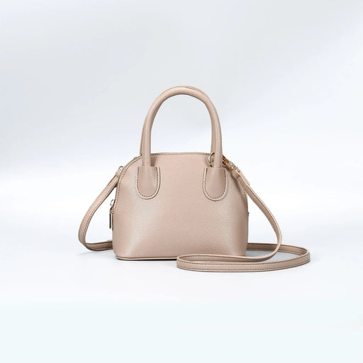 Beige handbag with a shoulder strap on a light gray background