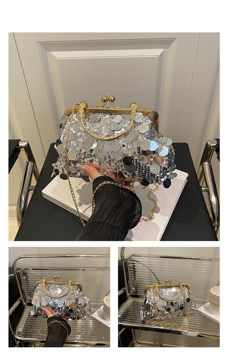 Crystal handbag with gold frame on a black surface, displayed against a neutral background.
