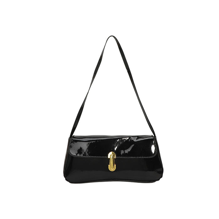 A black patent leather shoulder bag with a gold-tone J-shaped turn-lock clasp, displayed against a solid white background.