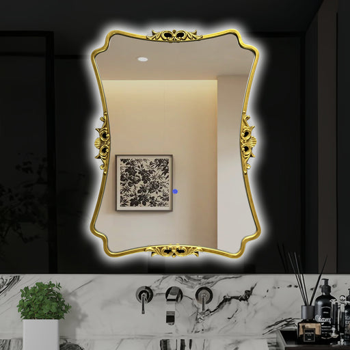 Decorative gold-framed mirror on a bathroom wall with marble countertop and decor items.