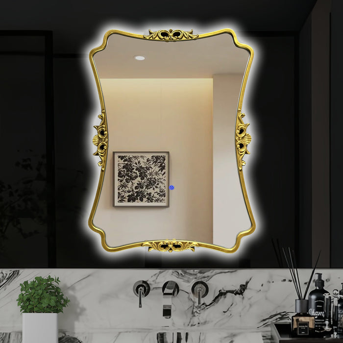Decorative gold-framed mirror on a bathroom wall with marble countertop and decor items.
