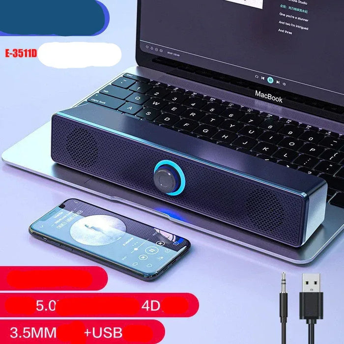 Laptop with a external soundbar and smartphone on a light purple background