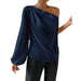 Navy blue one-shoulder top worn by a person on a white background