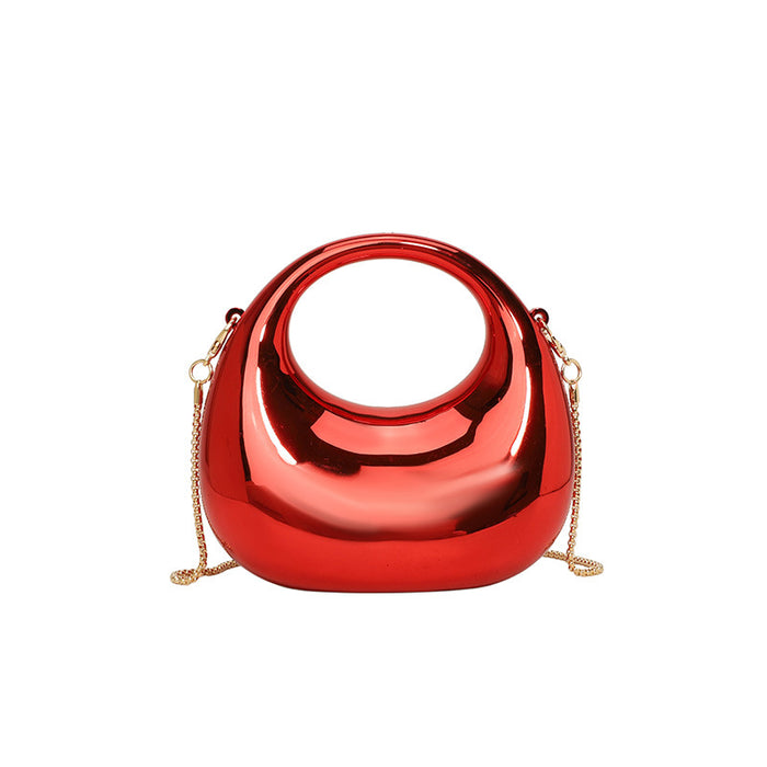 Shiny red handbag with a gold chain on a white background