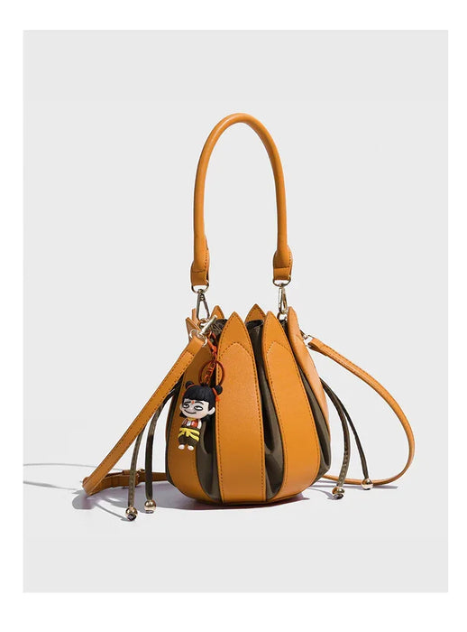 Brown handbag with a keychain on a white background