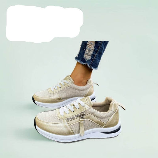Beige sneakers with white laces on a light green background