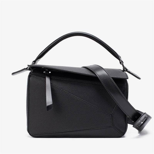 Black handbag with a strap on a white background