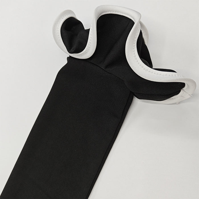 Black garment with white trim on a light gray background