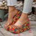 Colorful wedge sandals with a measurement label on a stone surface.
