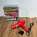 Red hair dryer with packaging on a wooden surface
