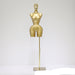 Gold mannequin on a stand against a white background