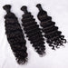 Three bundles of curly black hair extensions on a white background